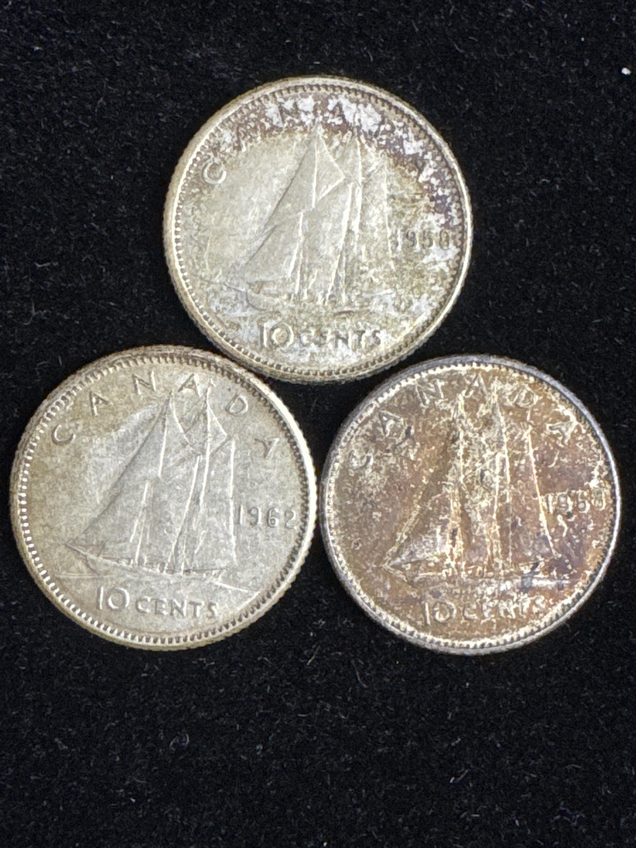 Three circulated Canadian Bluenose dimes dated 1958, 1962, and 1968